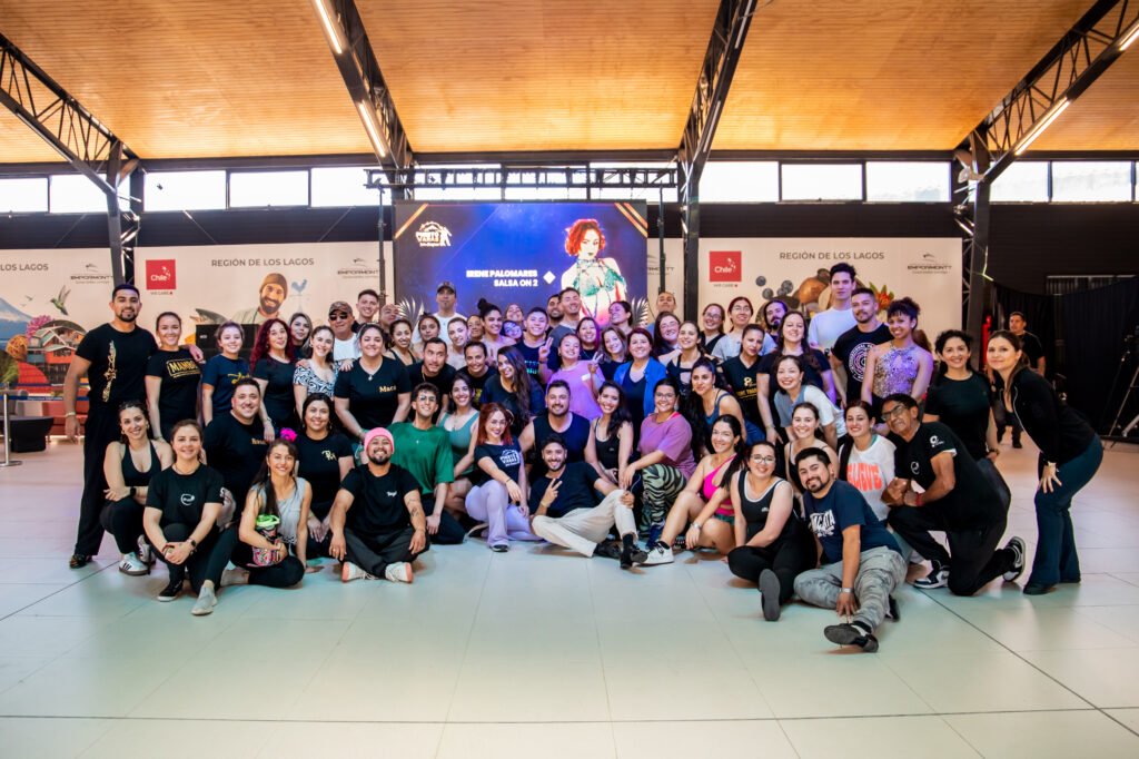 Students from Irene Palomares' On2 salsa workshop posing under the event banner